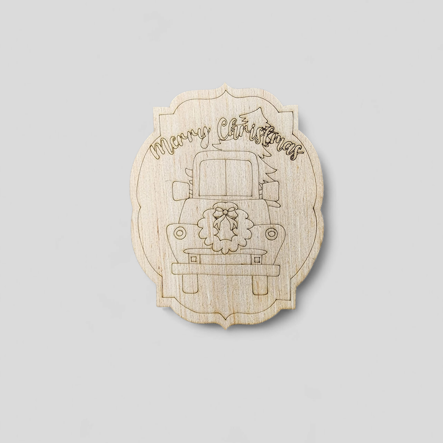 Unfinished wood blank with an engraved vintage truck, wreath, and the words "Merry Christmas".
