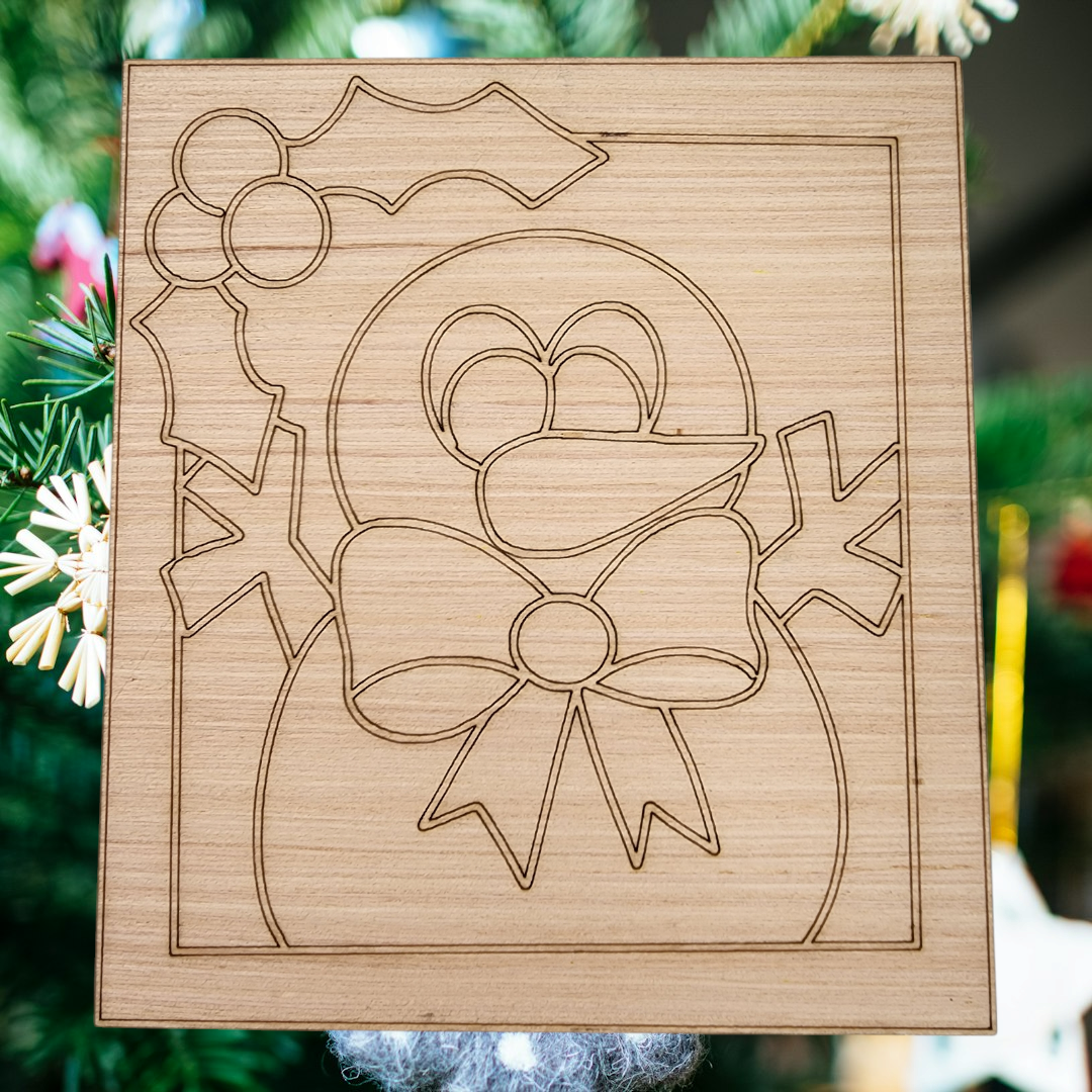 Unfinished square wood blank with an engraved design of a cute snowman with a bow tie and holly.