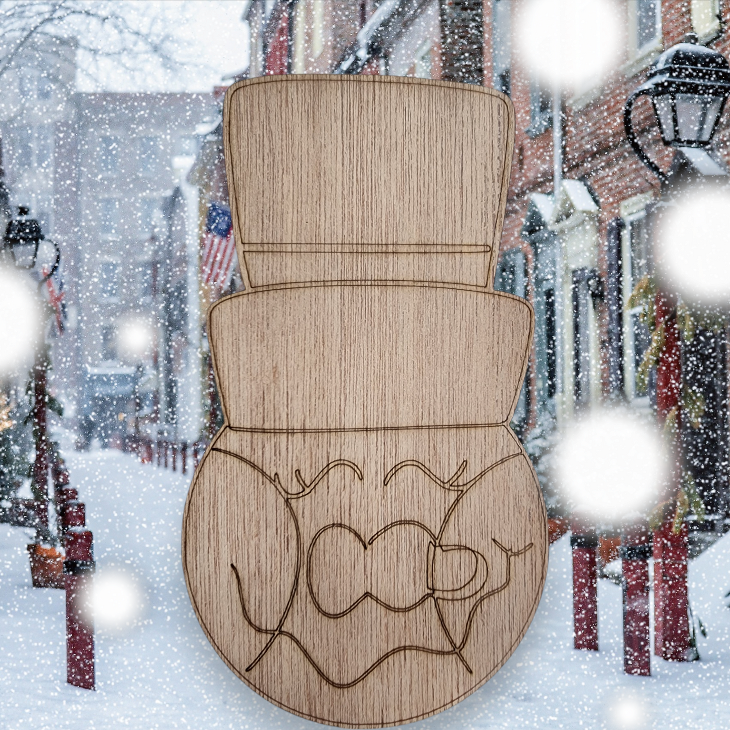 Unfinished wood cutout of a snowman head wearing a large top hat.