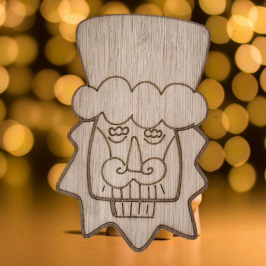Unfinished wood cutout of a Christmas nutcracker soldier's head.