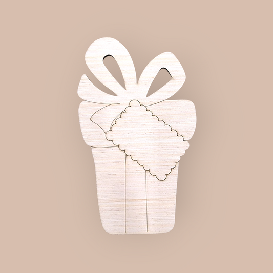 Unfinished wood ornament blank with an engraved design of a Christmas present, bow, and gift tag.