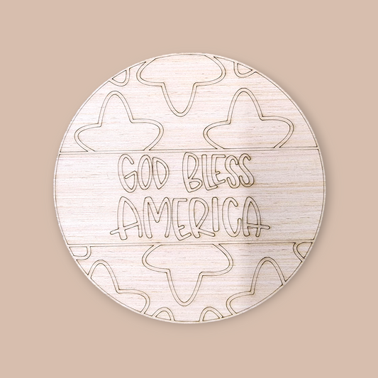 Unfinished round wood door hanger with an engraved "God Bless America" and a star pattern.