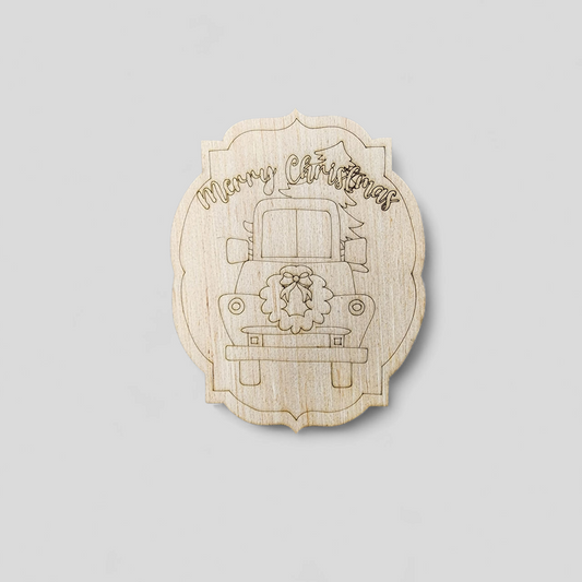 Unfinished wood blank with an engraved vintage truck, wreath, and the words "Merry Christmas".