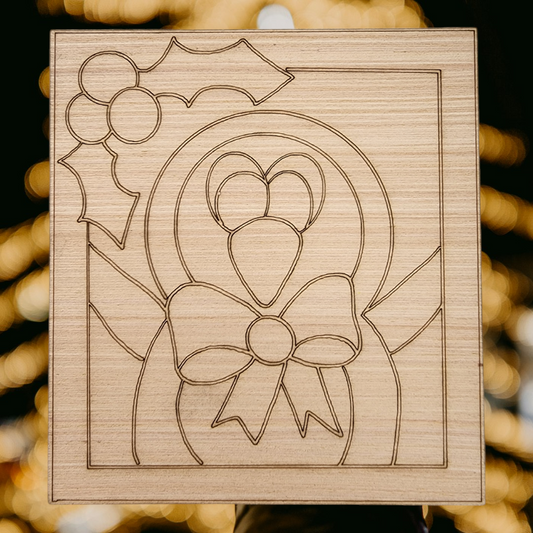 Unfinished square wood blank with an engraved design of a cute penguin with a bow tie and holly.