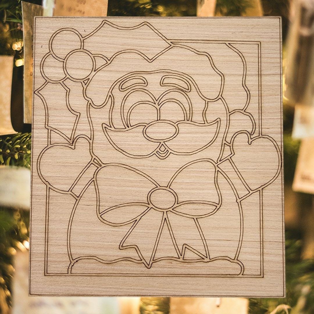 Unfinished square wood blank with an engraved design of a cute Santa Claus with a bow tie and holly.