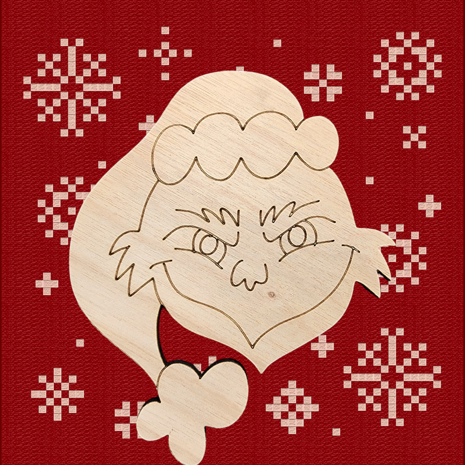 Unfinished wood cutout of a grumpy green Christmas character with a mischievous grin.