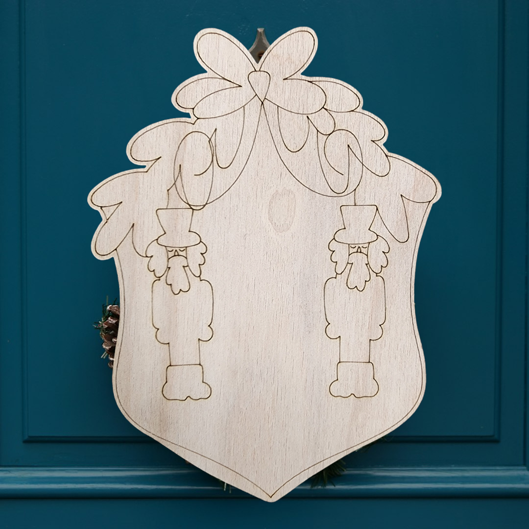 Unfinished wood nutcracker crest sign with a blank center for personalization.