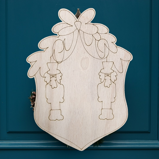 Unfinished wood nutcracker crest sign with a blank center for personalization.