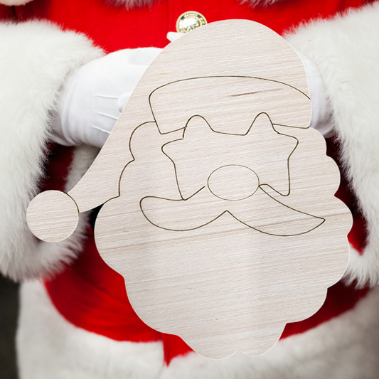 Santa Claus holding an unfinished wood craft blank of his own face.