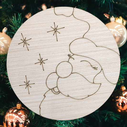 Unfinished round wood sign with an engraved design of Santa's sleigh and a reindeer.