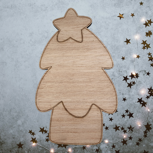 Unfinished wood Christmas tree cutout with a star on top for DIY holiday decor.